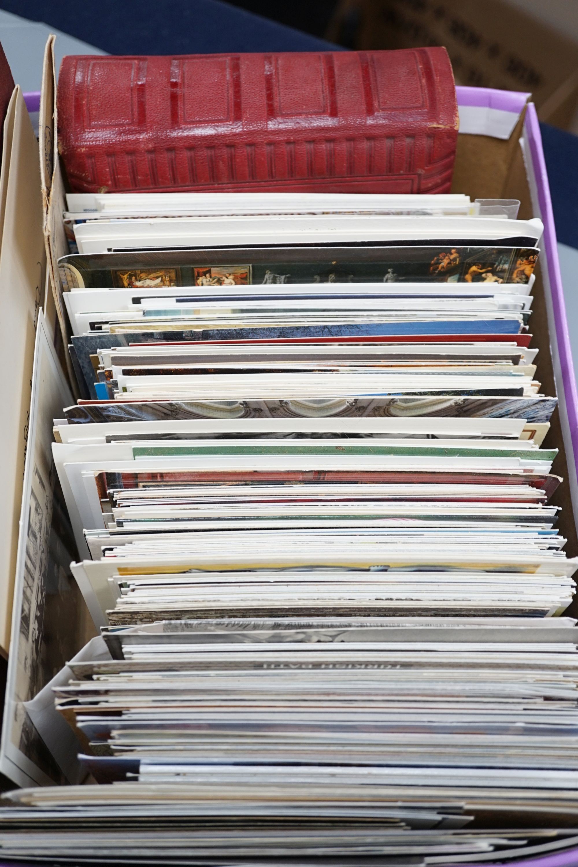 A collection of postcards, a photo album and an album of silks